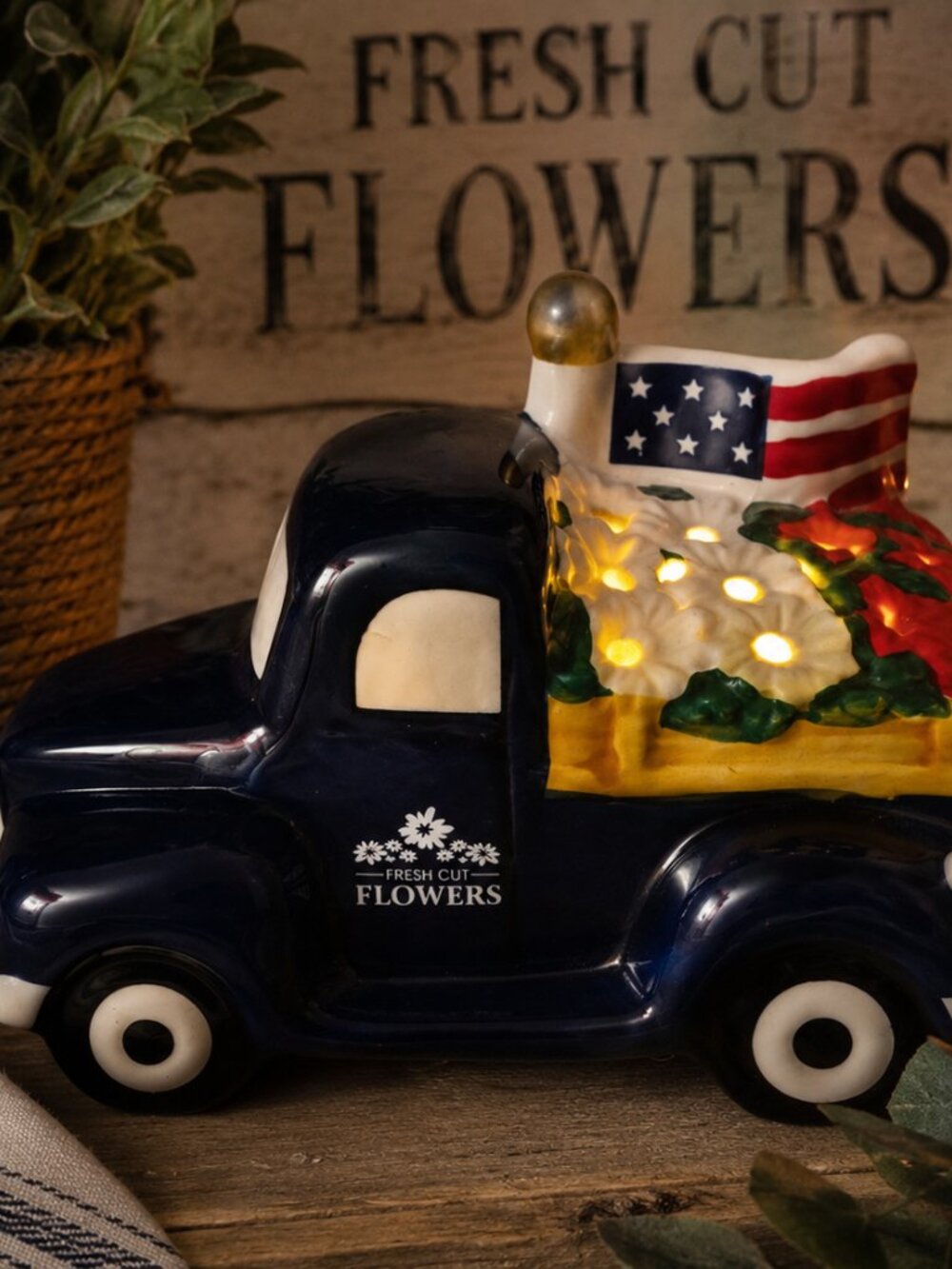 Navy Ceramic Truck Planter with Fresh Cut Flowers Logo
